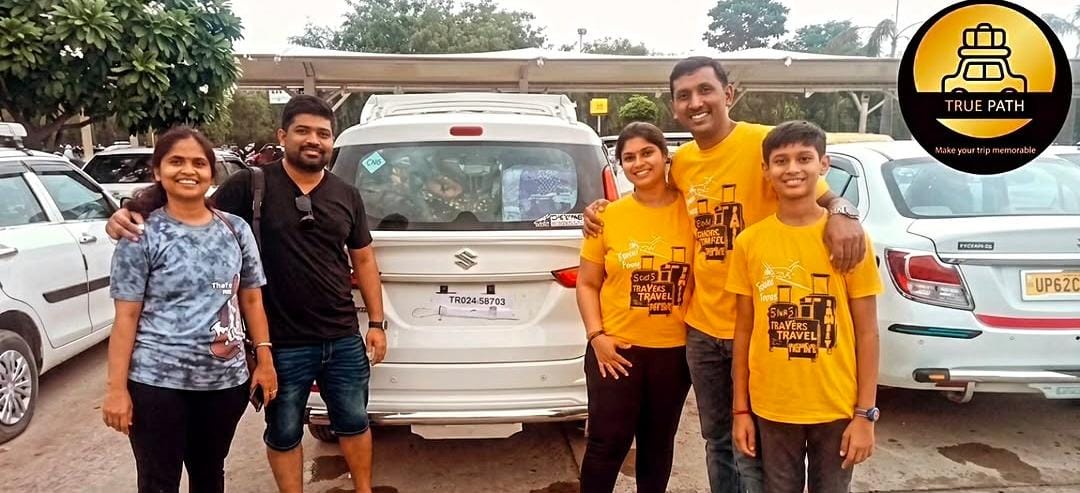 A family of five with their luggage loaded into a True Path Ertiga before setting off